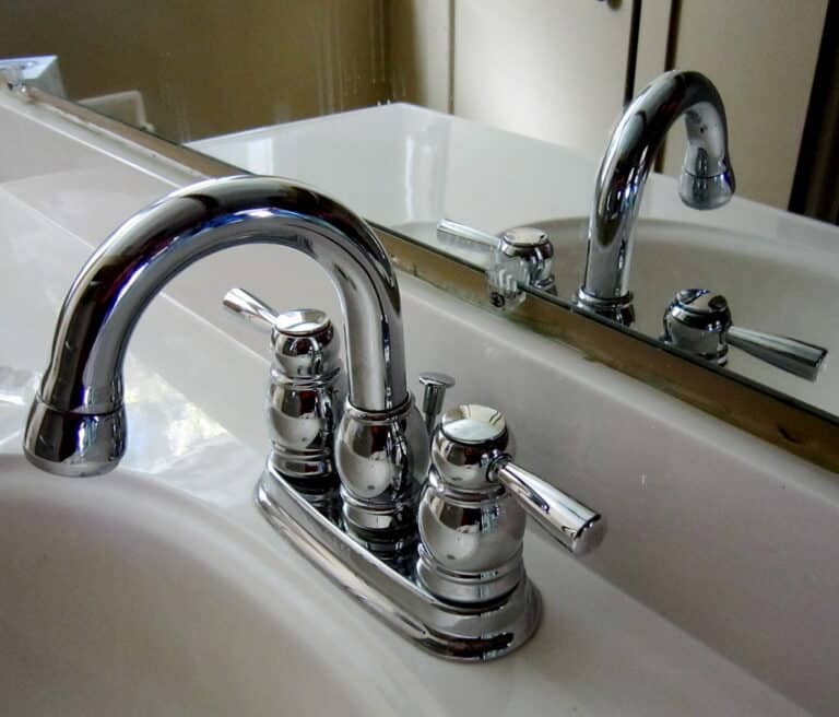 a silver sink faucet in a bathroom